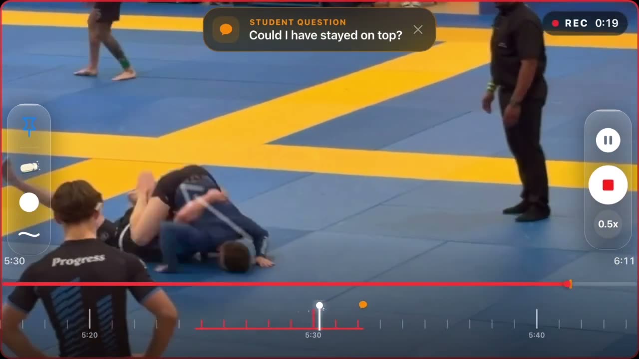 A paused competition match with the student's pinned question shown across the top of the frame.